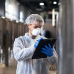 technologist-in-white-uniform-checking-quality-in-industrial-production-factory technologist-in-white-uniform-checking-quality-in-industrial-production-factory